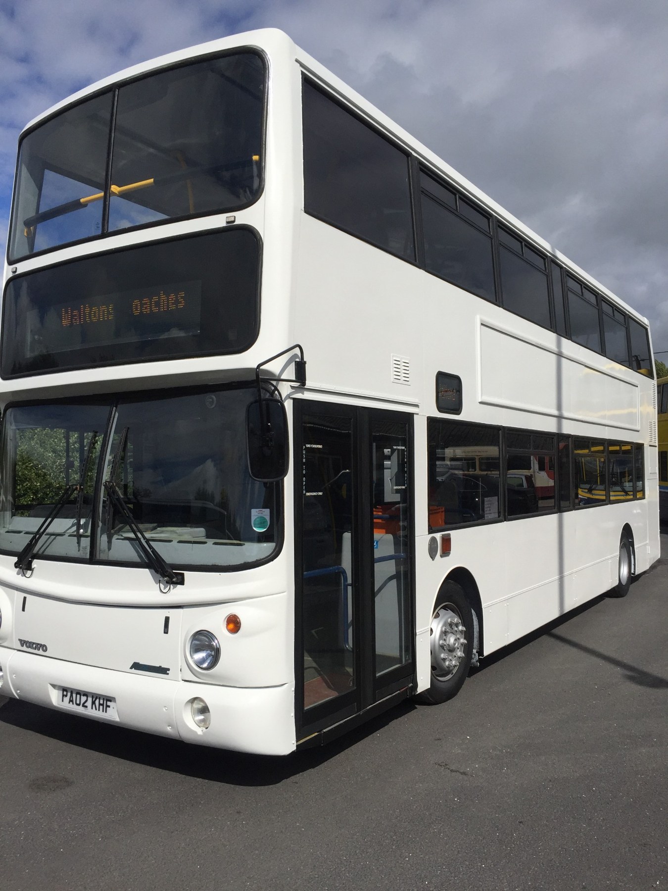White double-decker bus showing commercial vehicle paintwork